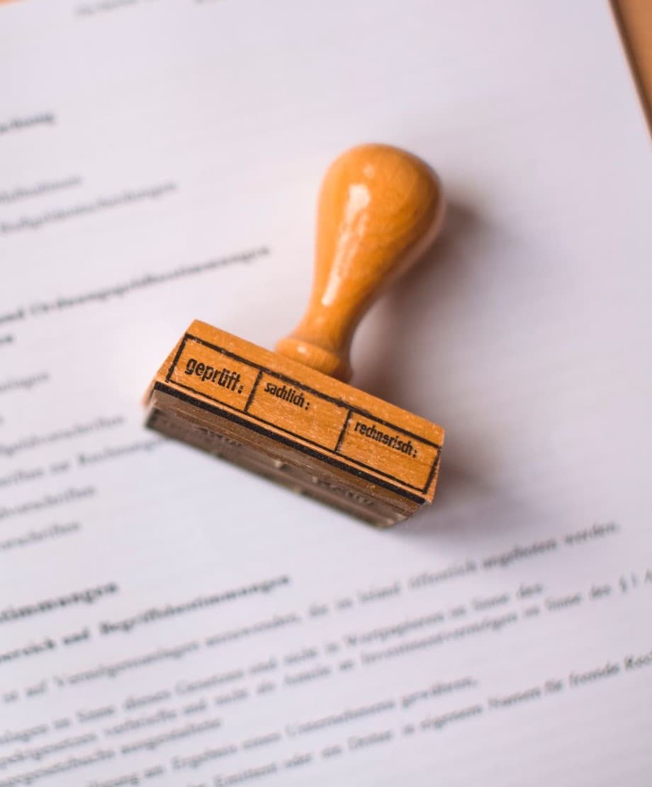 An audit stamp resting on an open statute book