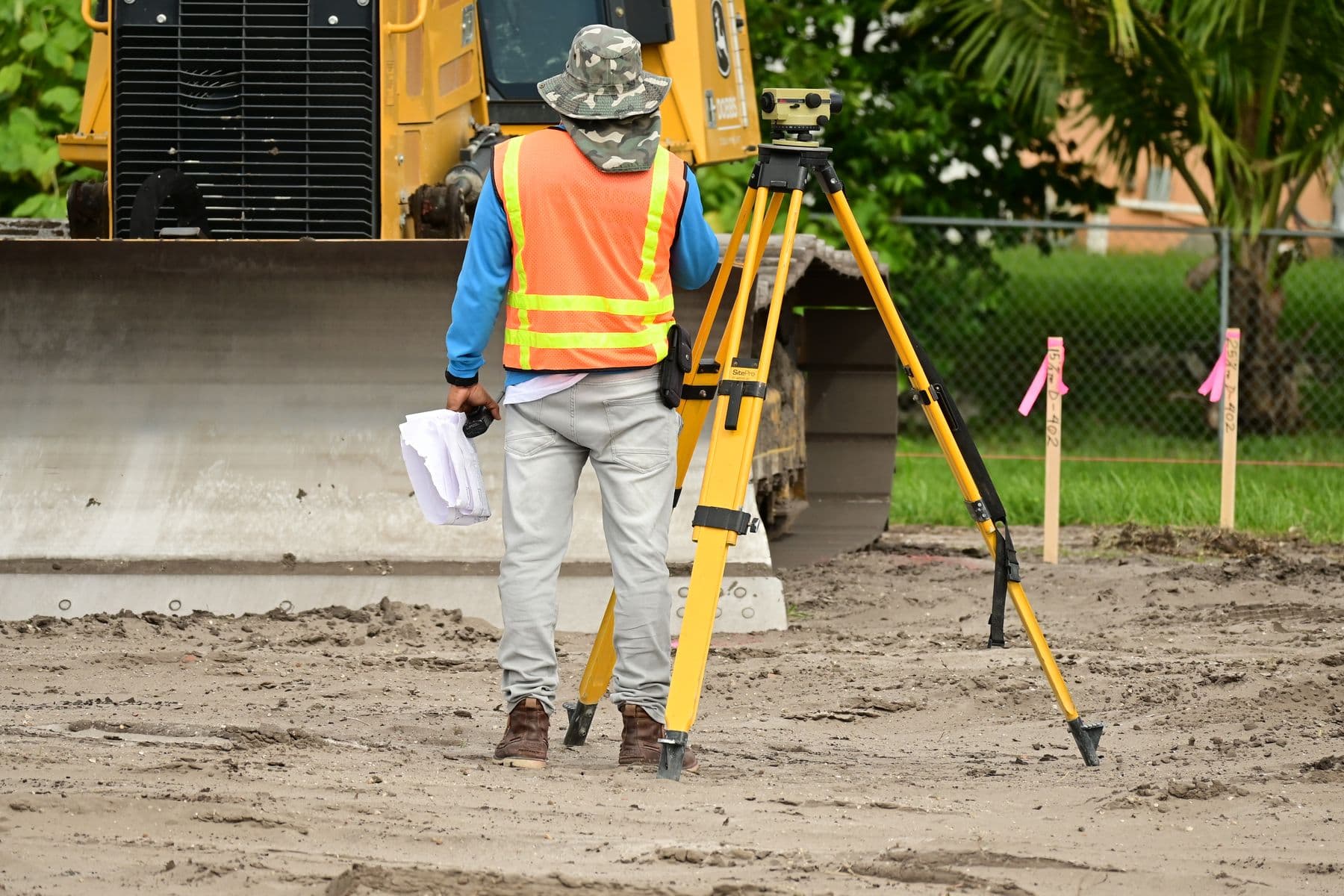 Surveyors setting a boundary marker on site